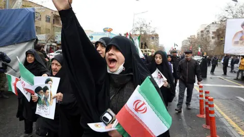 An Iranian woman reacts as she takes part in the Al-Quds (Jerusalem) Day rally, a commemoration in support of the Palestinian people on the last Friday of the Islamic holy month of Ramadan, in Tehran on March 13, 2026.